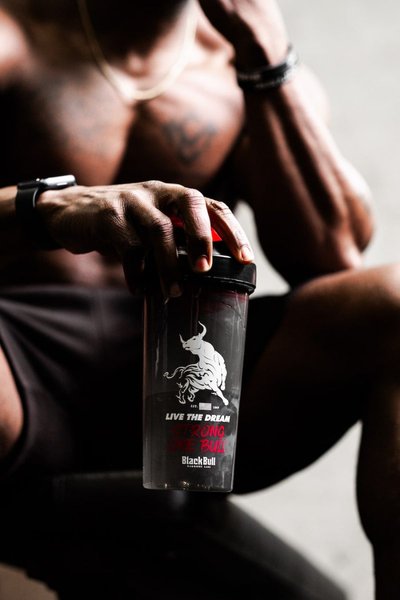 strong african man with protein shake