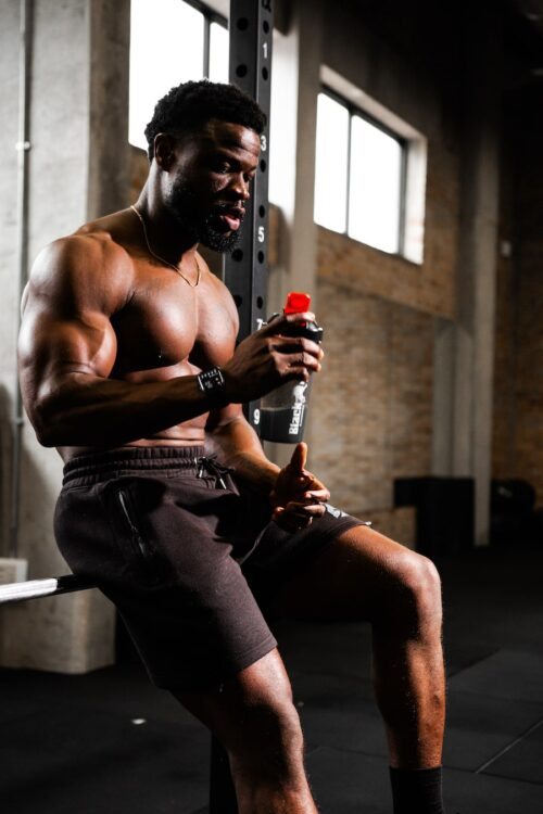 strong african man with protein shake